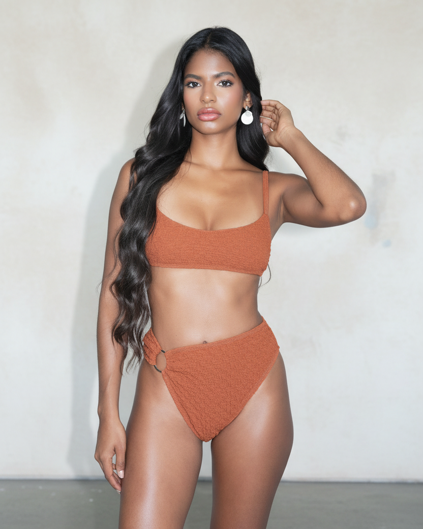 Woman wearing a rust-colored bikini against a plain background
